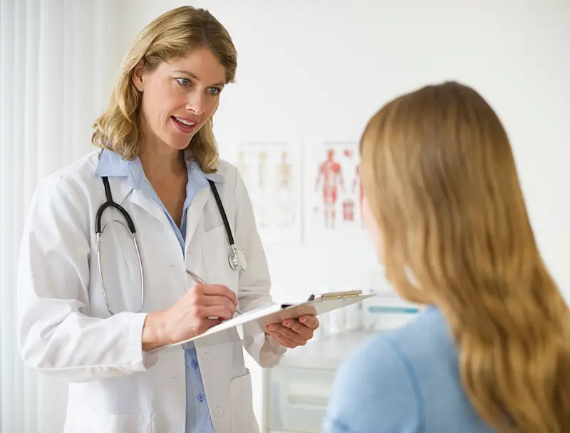 Doctor talking to patient with clipboard