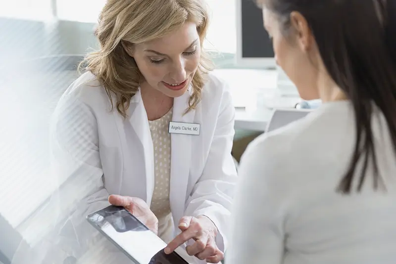 Doctor showing a patient test results on tablet