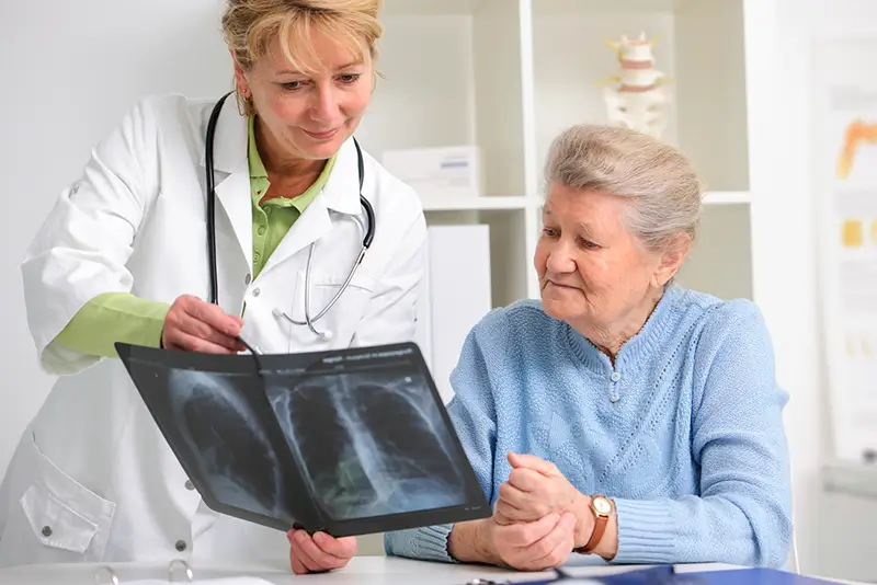 Doctor explaining scans to a elderly patient