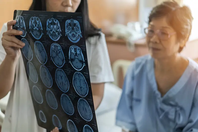 Nurse looking at patient brain scans