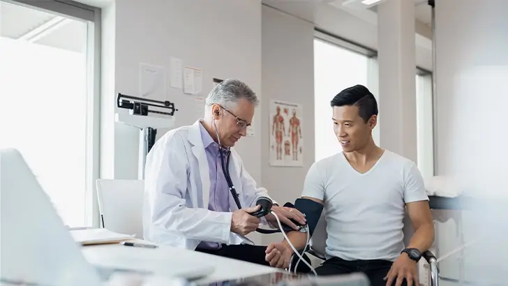 Doctor taking patients blood pressure