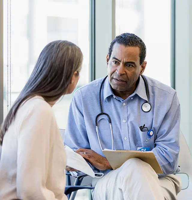 Clinician speaking to a patient 