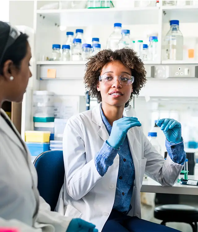 Researchers talking in a lab